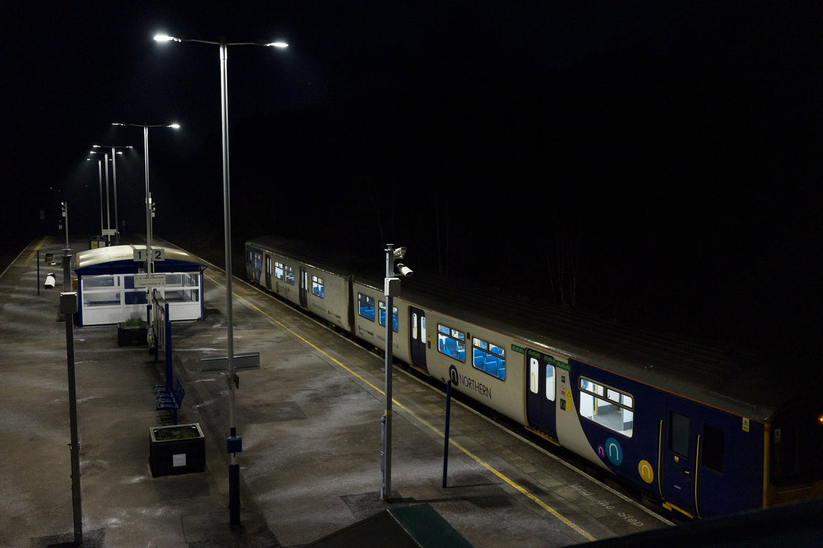 Image of a train on a platform at night.